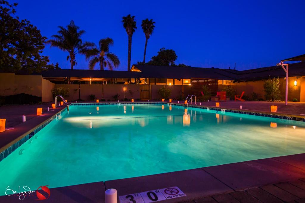 a swimming pool lit up at night at Carlton Oaks Lodge, Ascend Hotel Collection in Santee