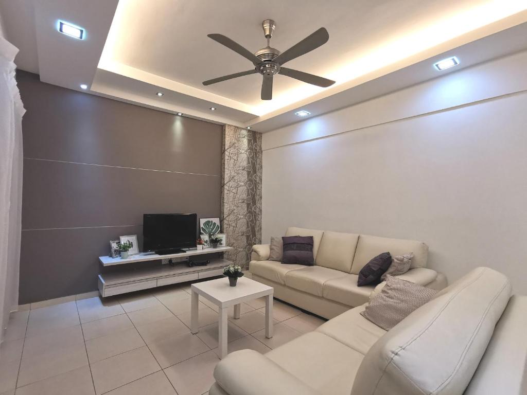 a living room with a couch and a ceiling fan at Menjalara Kepong Desapark & MITEC 中文房东- B16 in Kuala Lumpur