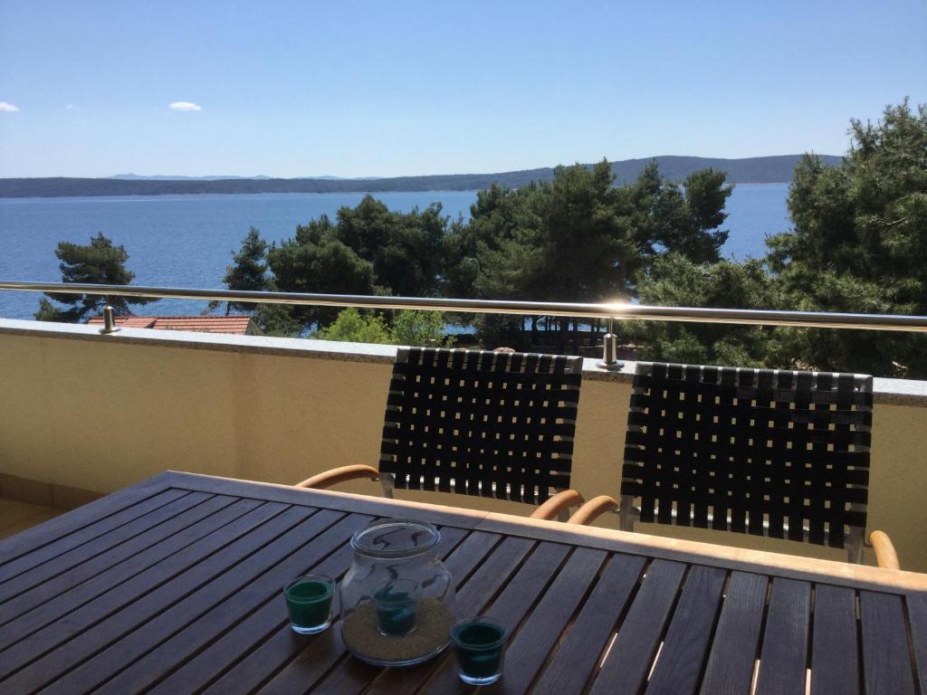 a table on a balcony with a view of the water at Casa-Gorma at the beach, Apartment 121 in Zavala