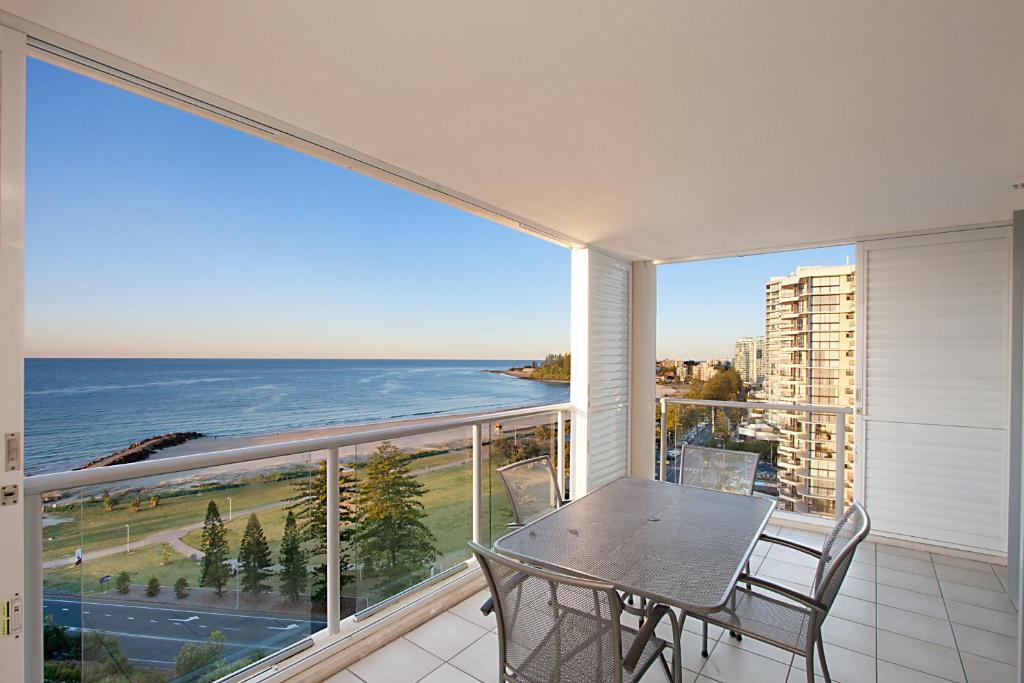 a dining room with a balcony overlooking the ocean at Blue C Coolangatta in Gold Coast