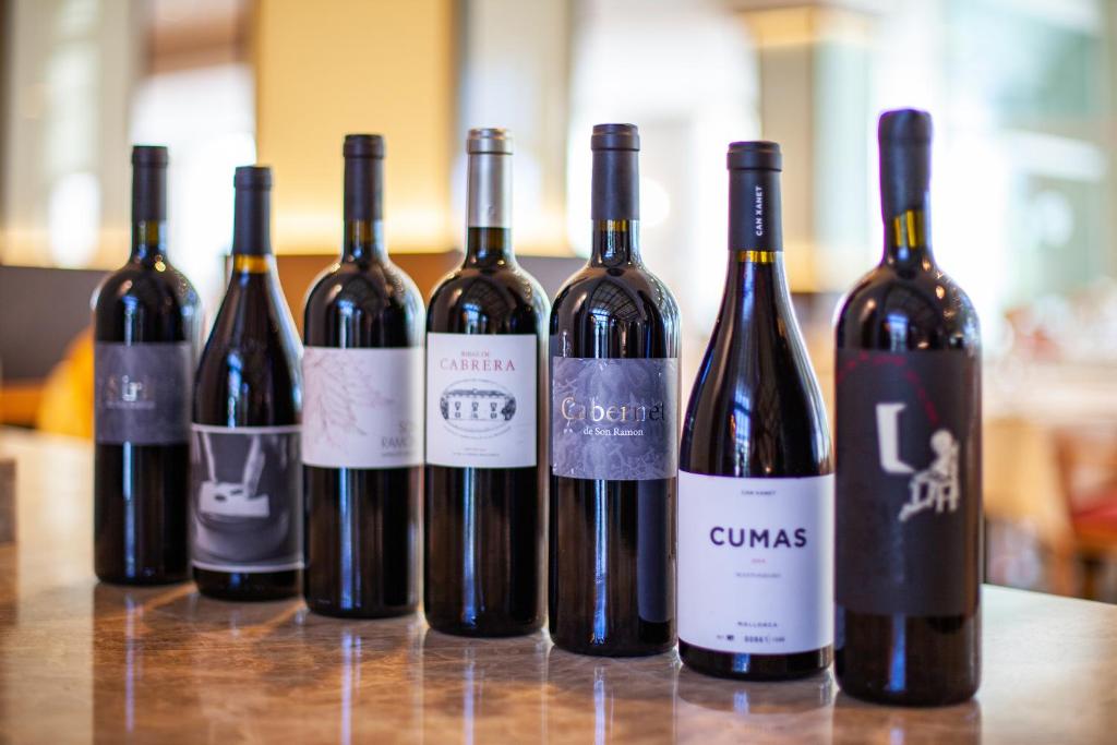 a group of wine bottles sitting on a table at Grupotel Parc Natural & Spa in Playa de Muro