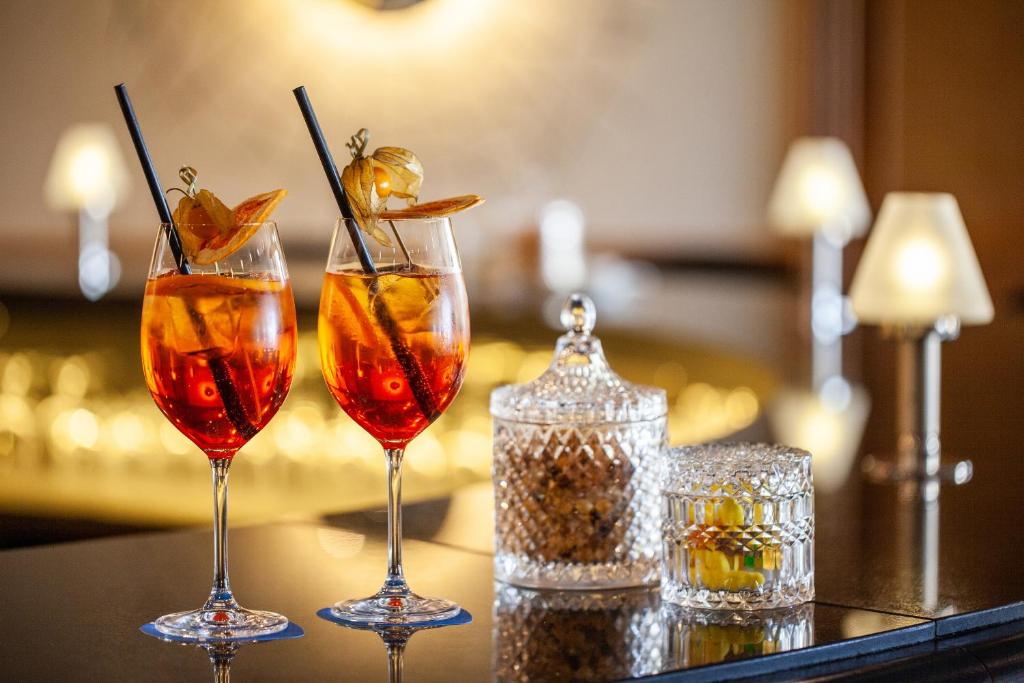 three cocktails in glasses sitting on a bar at Grupotel Parc Natural & Spa in Playa de Muro