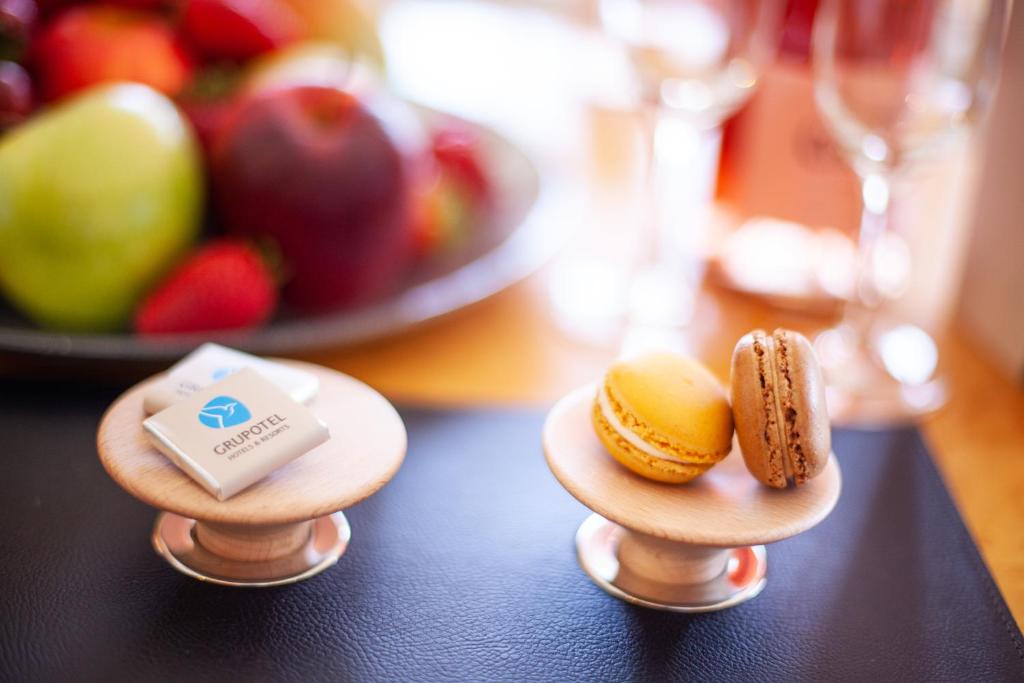 two small plates of food on a table with fruit at Grupotel Parc Natural & Spa in Playa de Muro