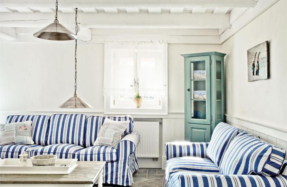 a living room with blue and white striped couches at Richňava park in Štiavnické Bane