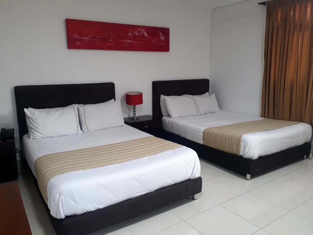 Postel nebo postele na pokoji v ubytování Hotel Poblado Campestre