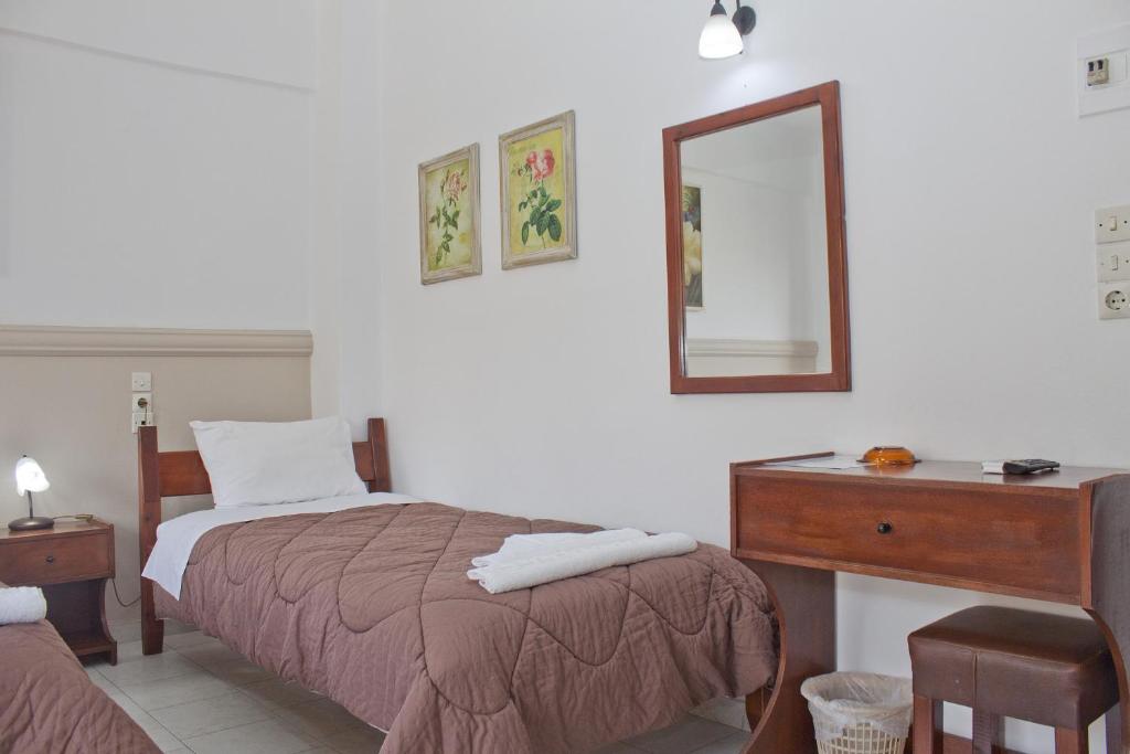 Postel nebo postele na pokoji v ubytování Danaos Hotel