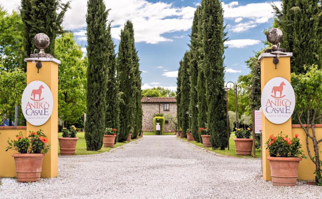 a driveway leading to an entrance to an estate with trees at Antico Casale in Sarzana