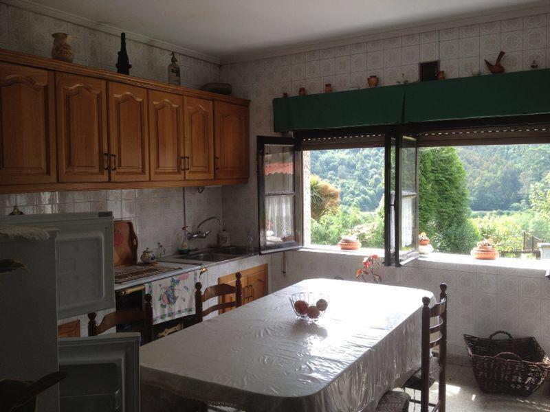 a kitchen with a table and some windows and a table at MRZ Rentals San Martín de Luiña in San Martín de Luiña