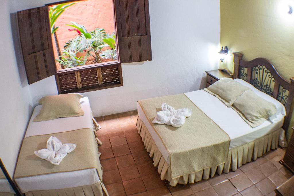 Postel nebo postele na pokoji v ubytování Casa Hotel Guaracú