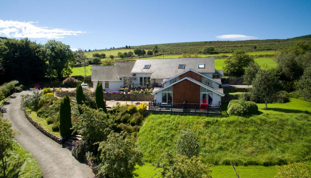 a house on a hill with a road at Wicklow Way Lodge in Wicklow