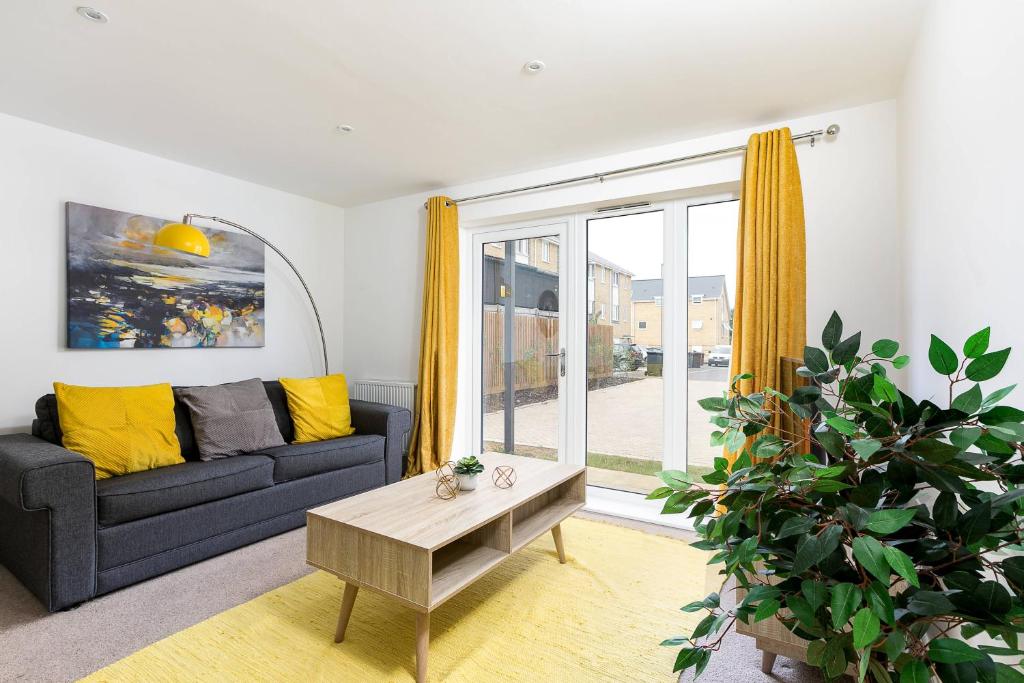 a living room with a couch and a table at Hertford Serviced Apartments by Payman Club in Hertford
