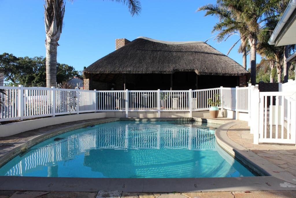 a swimming pool with a fence and a gazebo at Framesby Guesthouse in Port Elizabeth