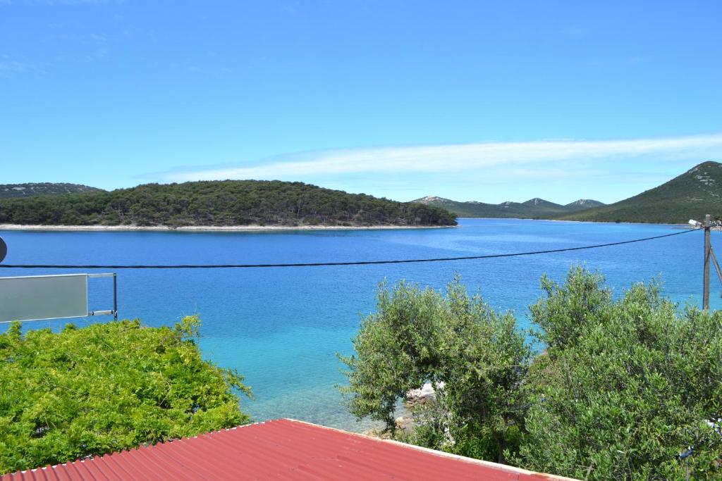 a view of a large body of water with trees at Corto Maltese in Brgulje