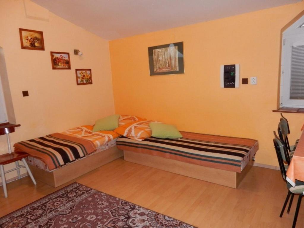A bed or beds in a room at Penzión Bajo