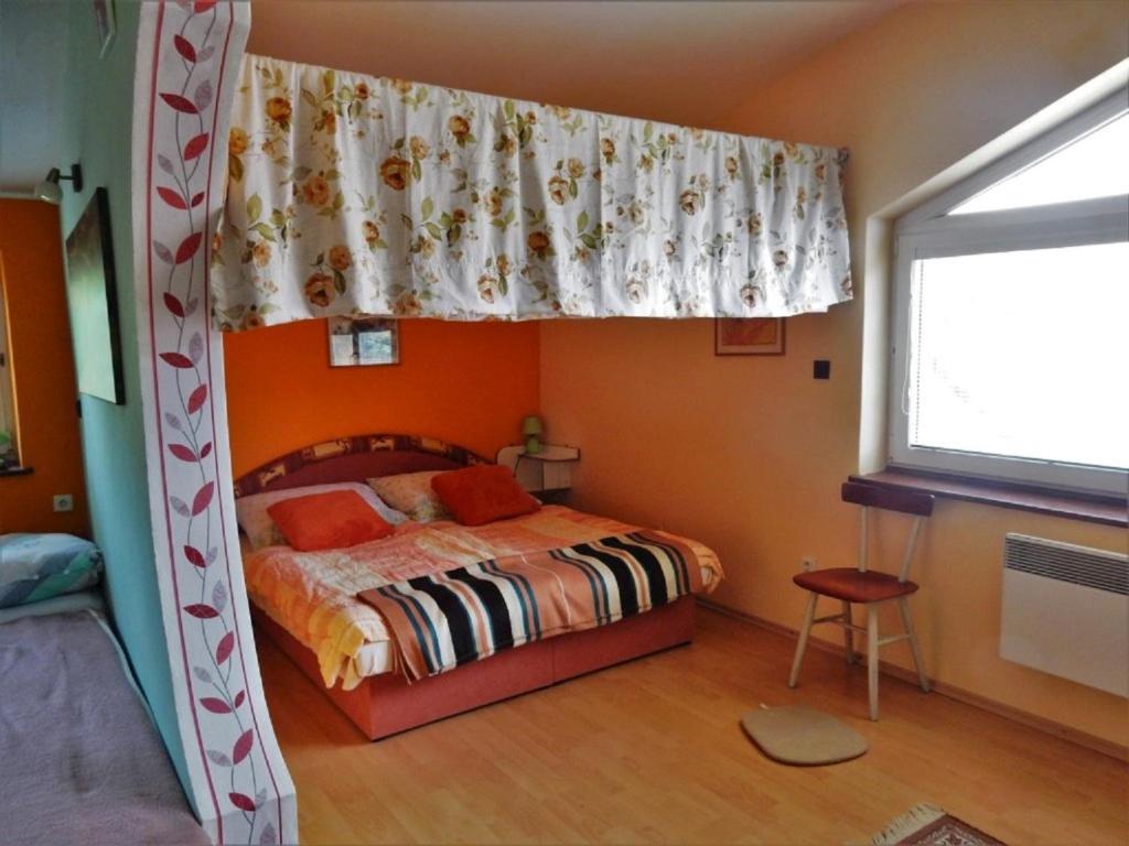 A bed or beds in a room at Penzión Bajo