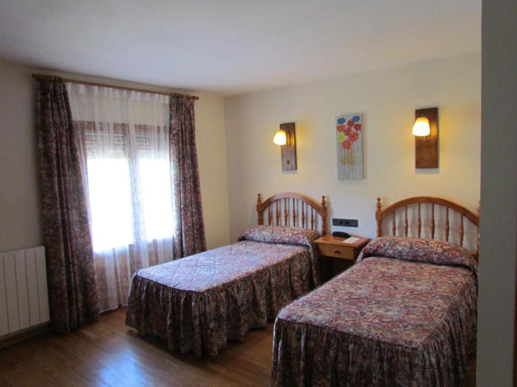 Postel nebo postele na pokoji v ubytování Hotel Las Nieves