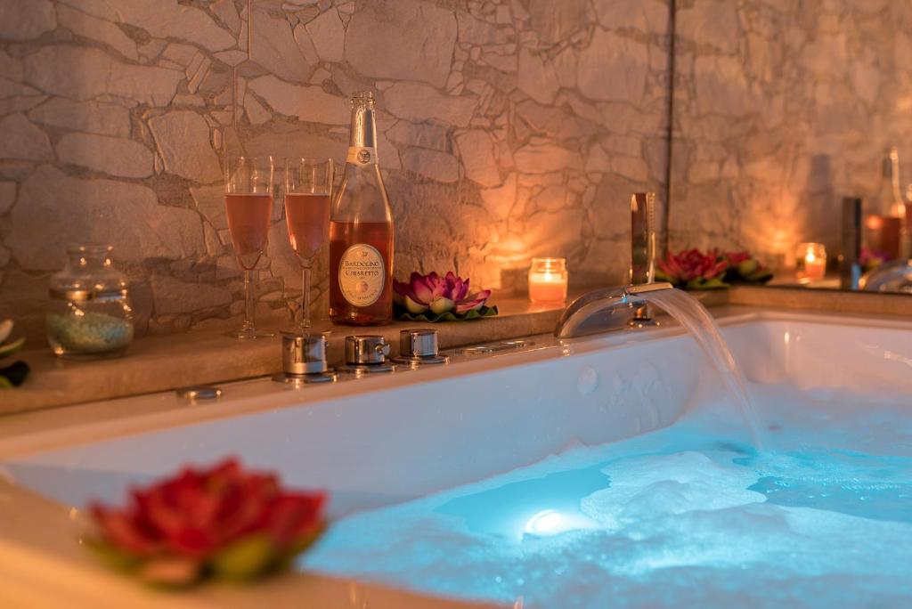 a bath tub with a bottle of champagne in it at B&b The Dream in Marina di Carrara