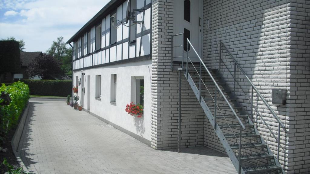 a brick building with a staircase on the side of it at Ferienwohnung Schroiff in Simmerath