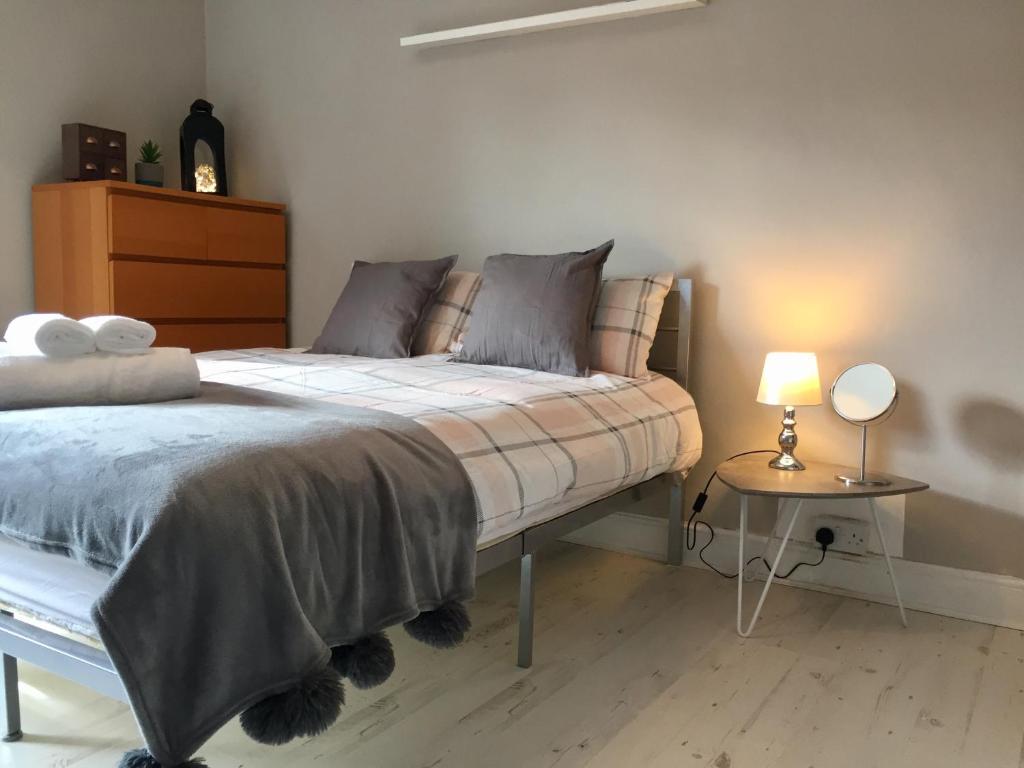 um quarto com uma cama e uma mesa lateral em THE LIMES Guest House em Birmingham