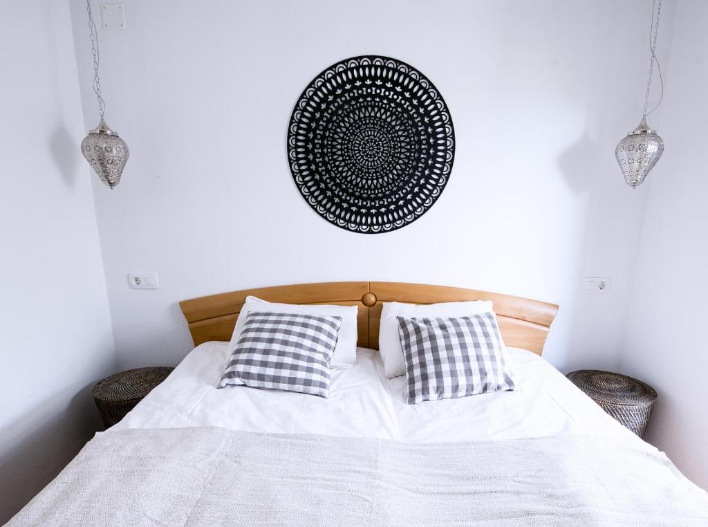 a bedroom with a white bed with two pillows at Apartmaji Baron in Bled