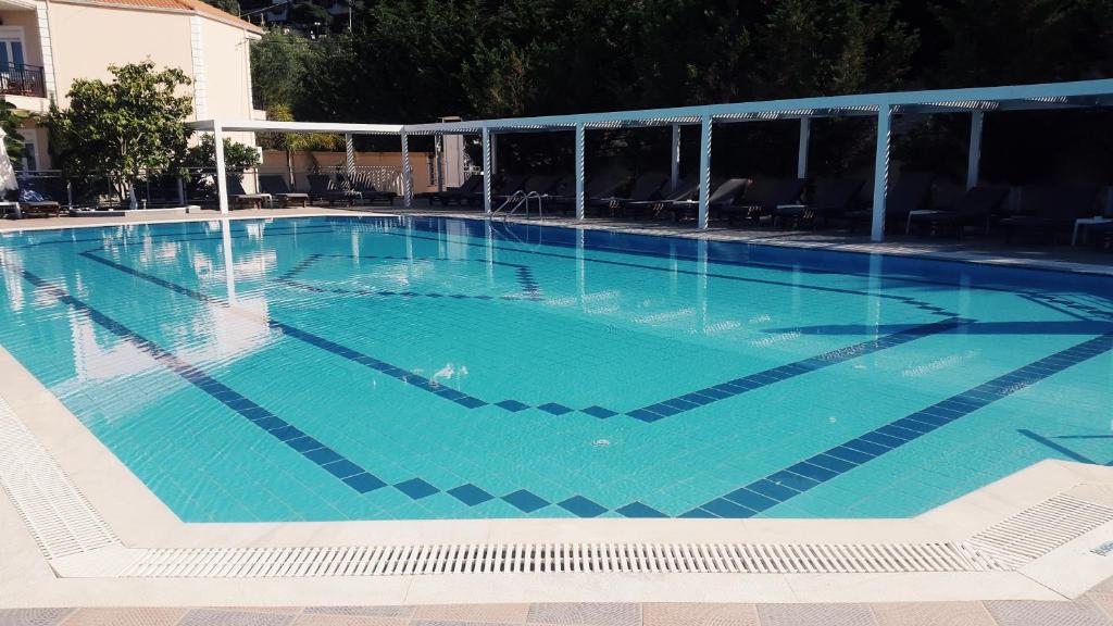 a large swimming pool with blue water at Alea Resort in Parga