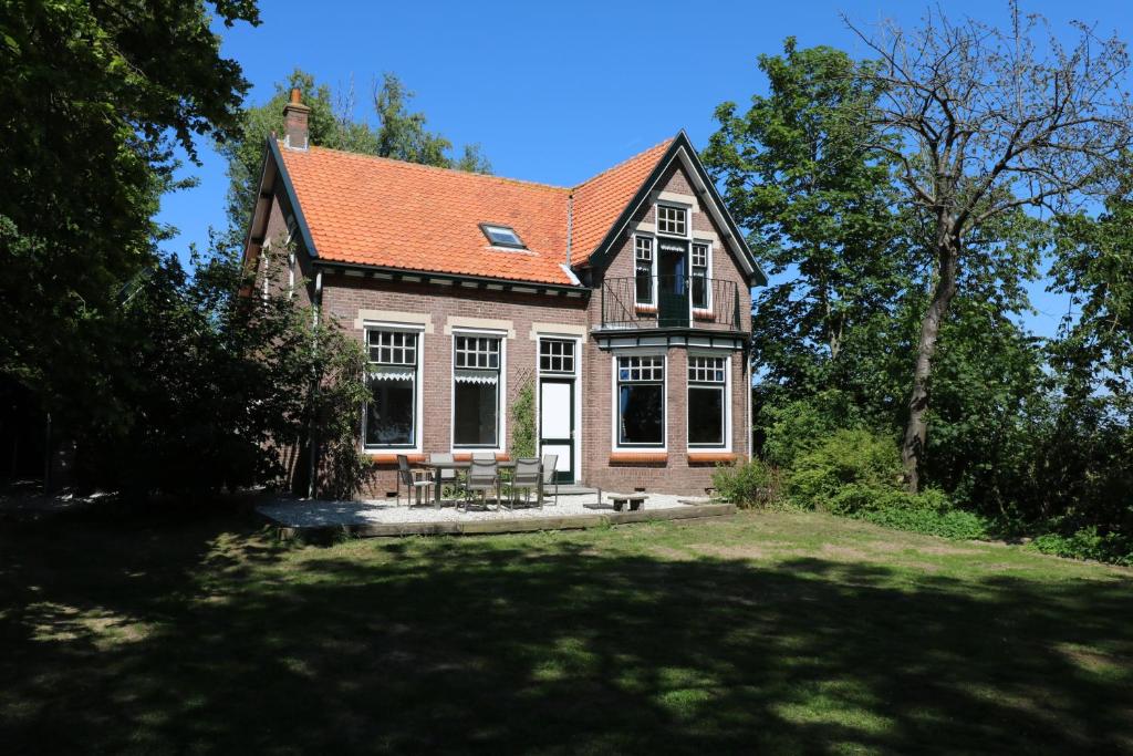 a house with a lawn in front of it at Huize Adriana in Wolphaartsdijk