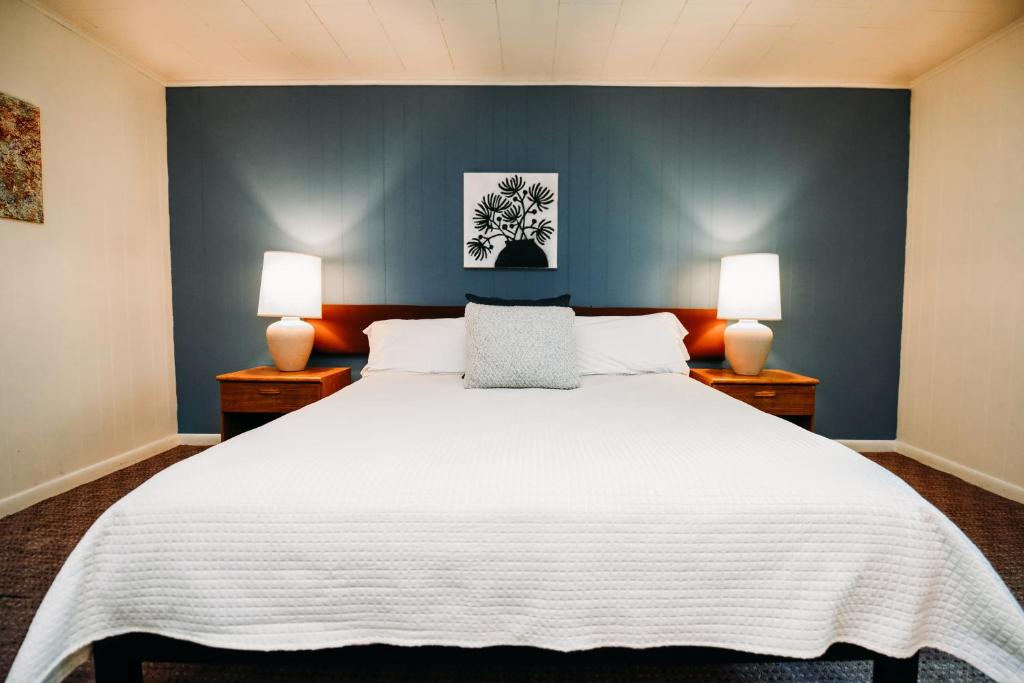 a bedroom with a large white bed with two lamps at Rainbow Mountain Resort - LGBTQ Friendly in East Stroudsburg