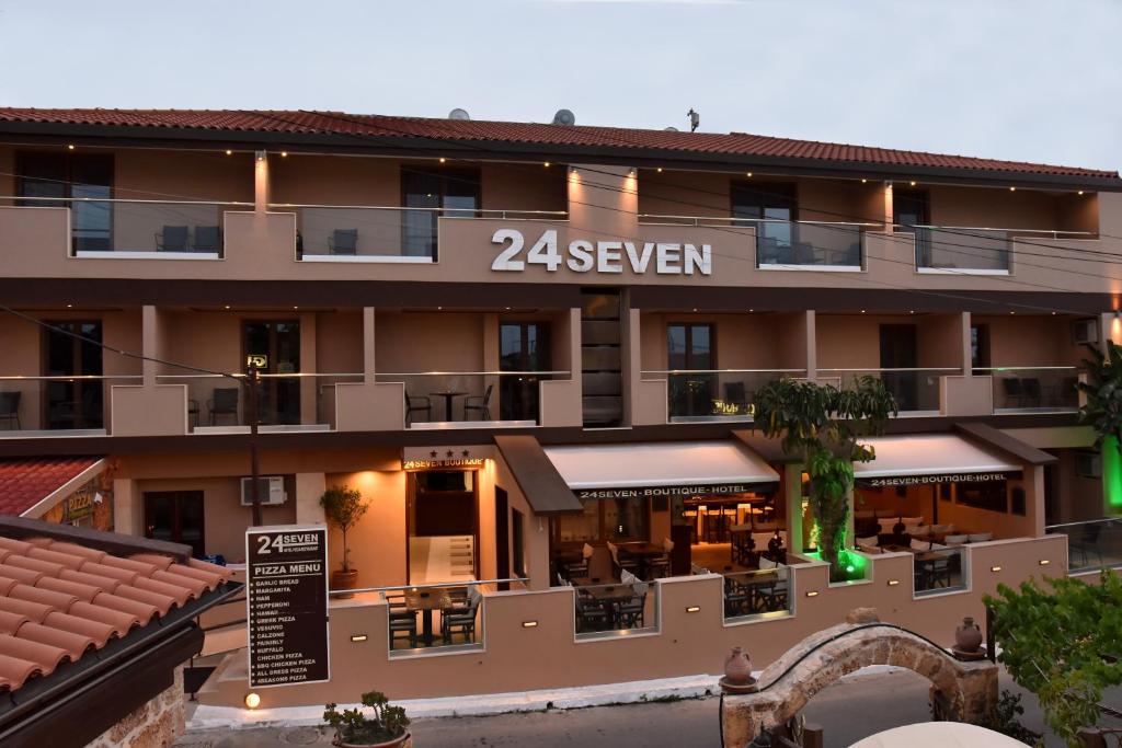 a hotel with a sign that reads seven at 24 Seven Boutique Hotel in Malia