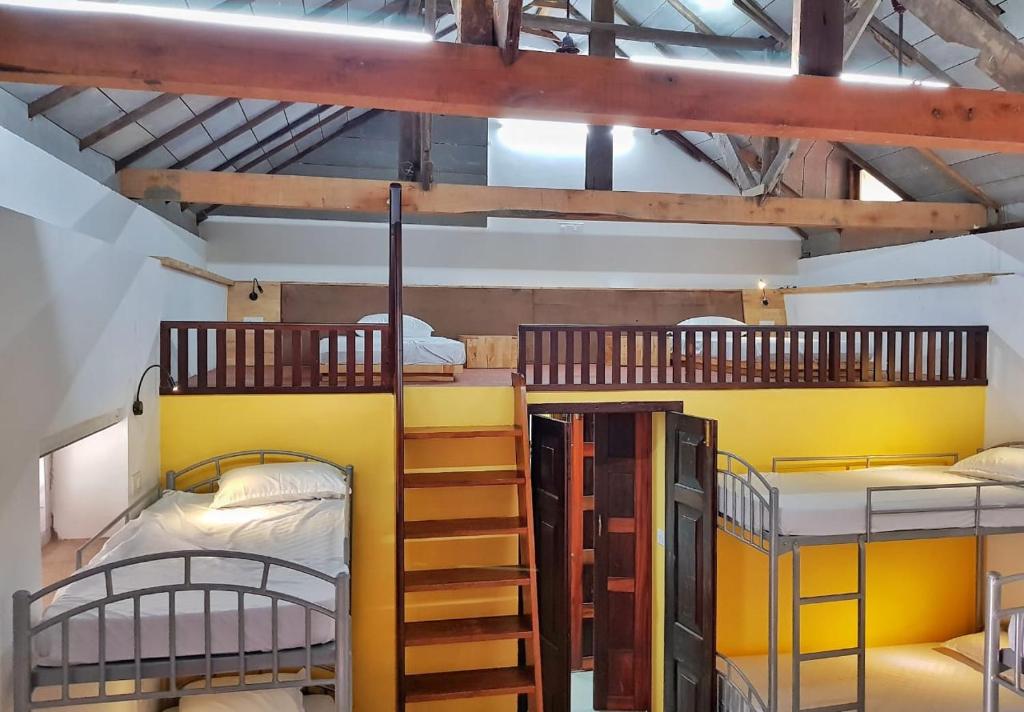 a room with three bunk beds and a staircase at Design Ashram in Kozhikode
