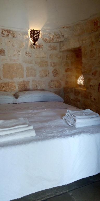 Postel nebo postele na pokoji v ubytování Trulli di Ivana