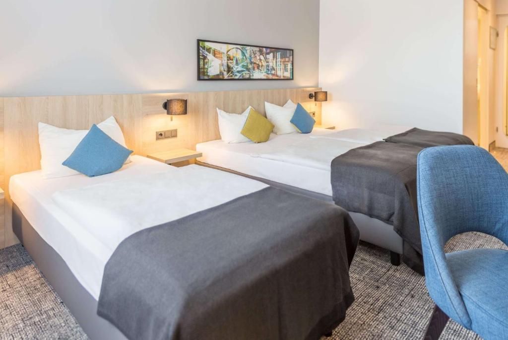 Postel nebo postele na pokoji v ubytování Ramada by Wyndham Flensburg City