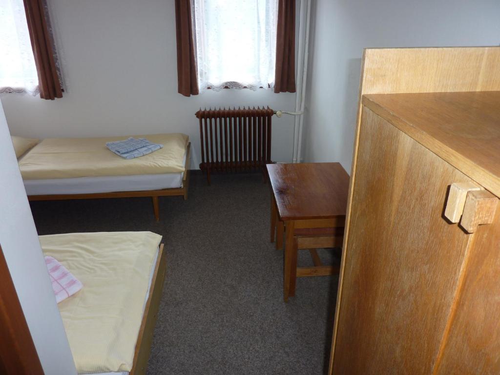 Postel nebo postele na pokoji v ubytování Hotel Flora Dolní Mísečky