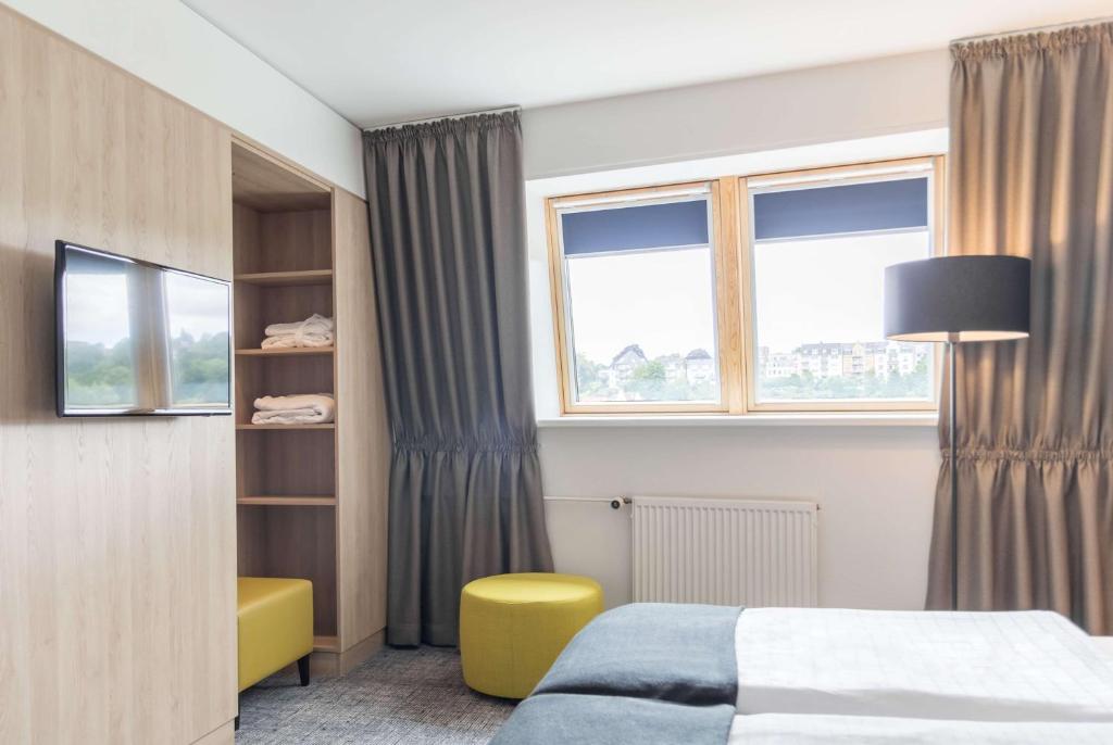 Postel nebo postele na pokoji v ubytování Ramada by Wyndham Flensburg City