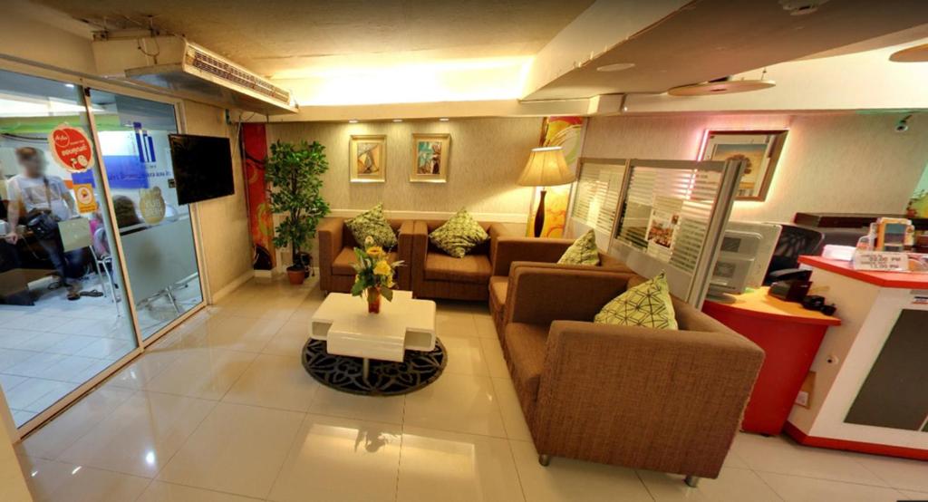 a lobby with couches and a table in a store at The Richy Place Guest House in Bangkok