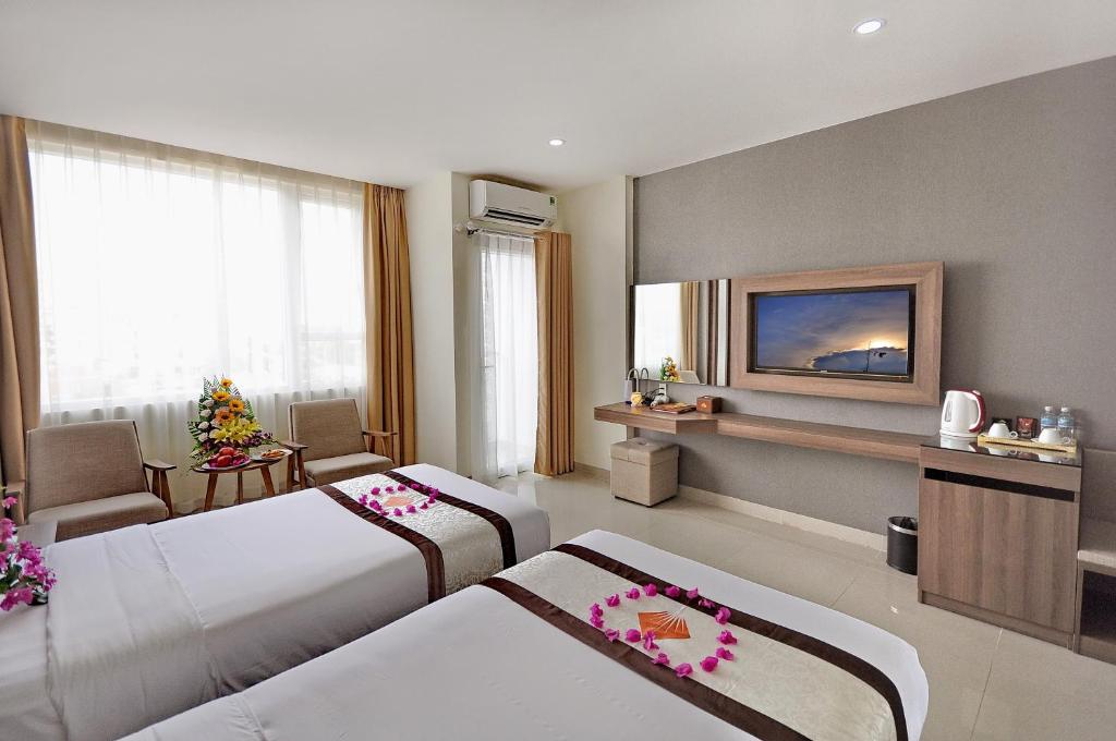 Postel nebo postele na pokoji v ubytování Rigel Hotel