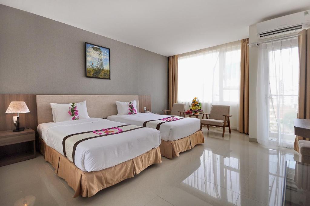 Postel nebo postele na pokoji v ubytování Rigel Hotel