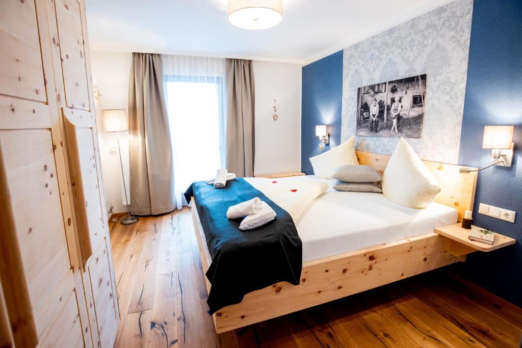 - une chambre avec un grand lit aux murs bleus dans l'établissement Kärnten Apartment Turnersee, à Sankt Kanzian