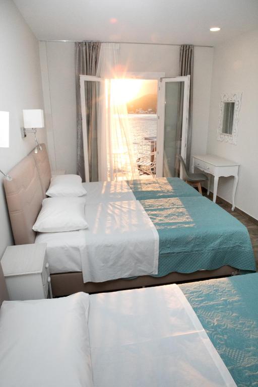 Postel nebo postele na pokoji v ubytování Hyperion Hotel