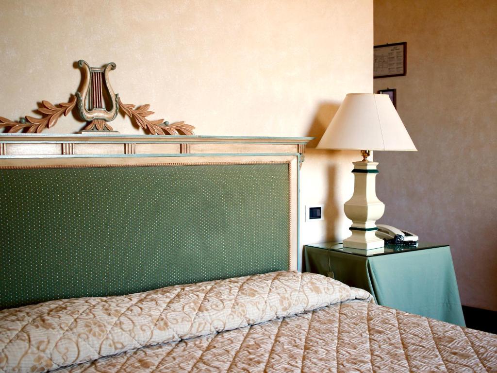 Postel nebo postele na pokoji v ubytování Relais Ducale