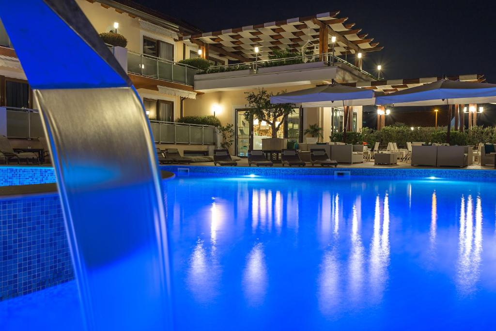 a swimming pool in front of a house at night at Hotel Porta Rosa in Ascea