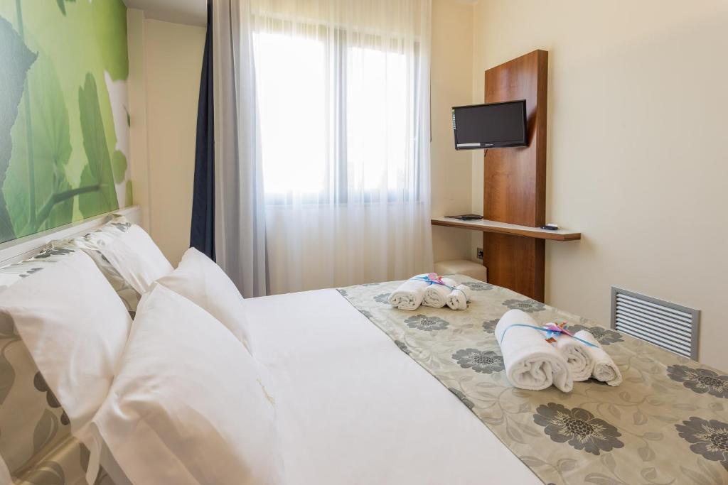 Postel nebo postele na pokoji v ubytování Hotel Porta Rosa