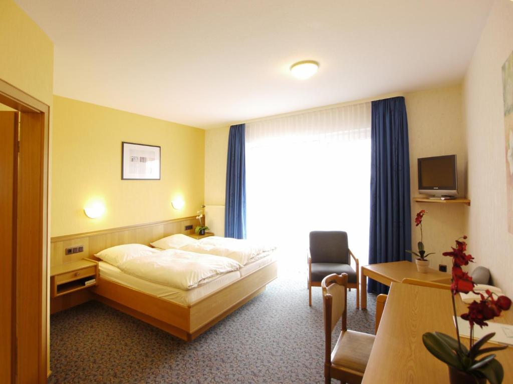 Postel nebo postele na pokoji v ubytování Hotel Hesborner Kuckuck