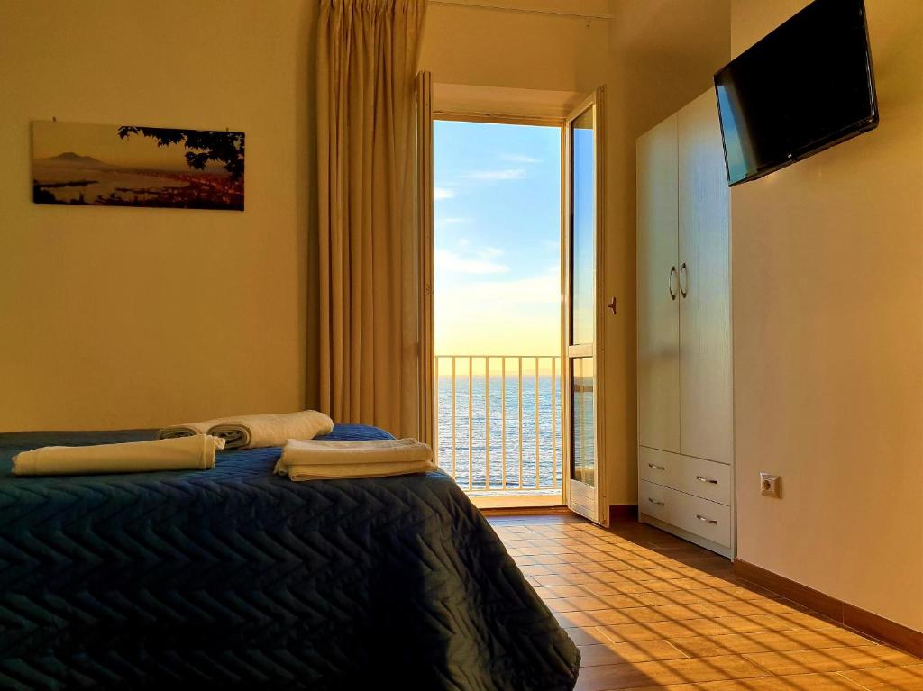 a bedroom with a bed with a view of the ocean at Il Veliero in Castellammare di Stabia