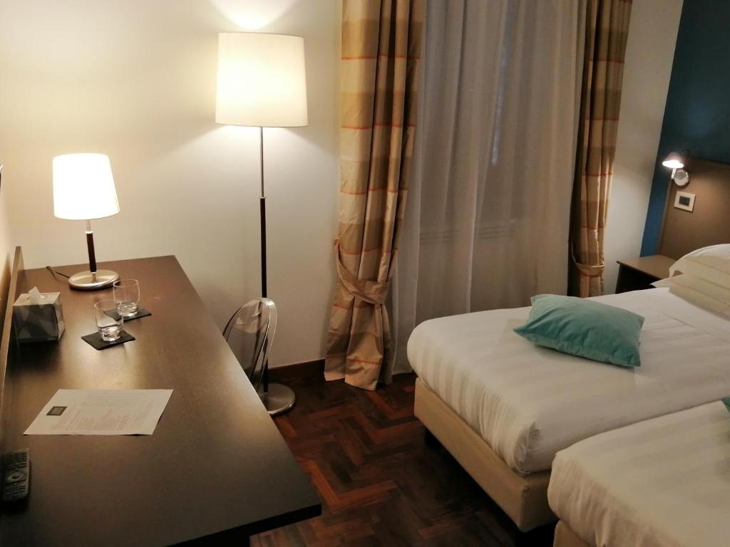 Postel nebo postele na pokoji v ubytování Locanda Giustini