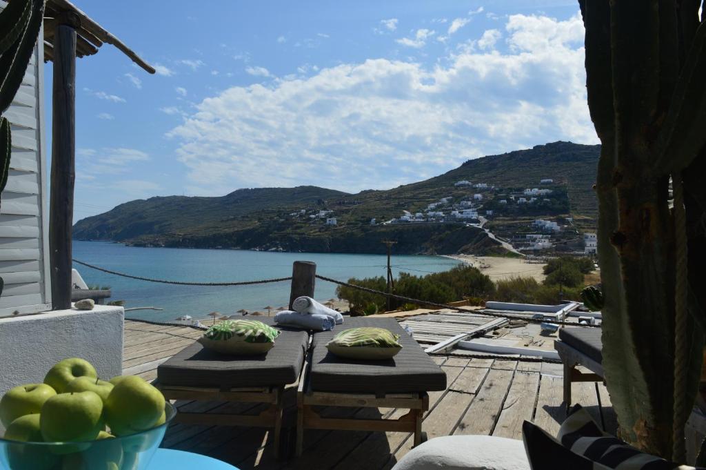 a patio with a table with a view of the water at Sea Side Studios & Houses in Kalo Livadi