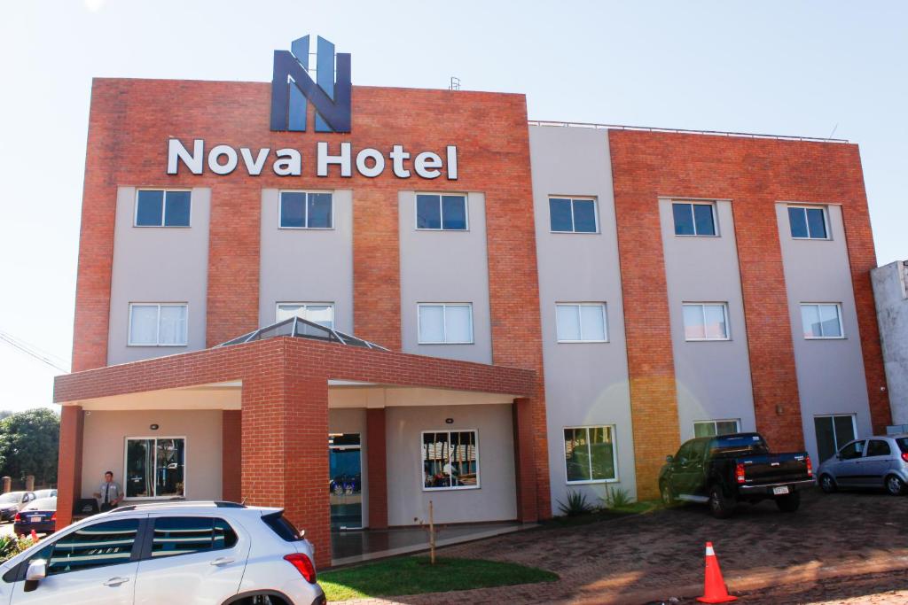 a nova hotel with a car parked in front of it at Nova Hotel in Ciudad del Este