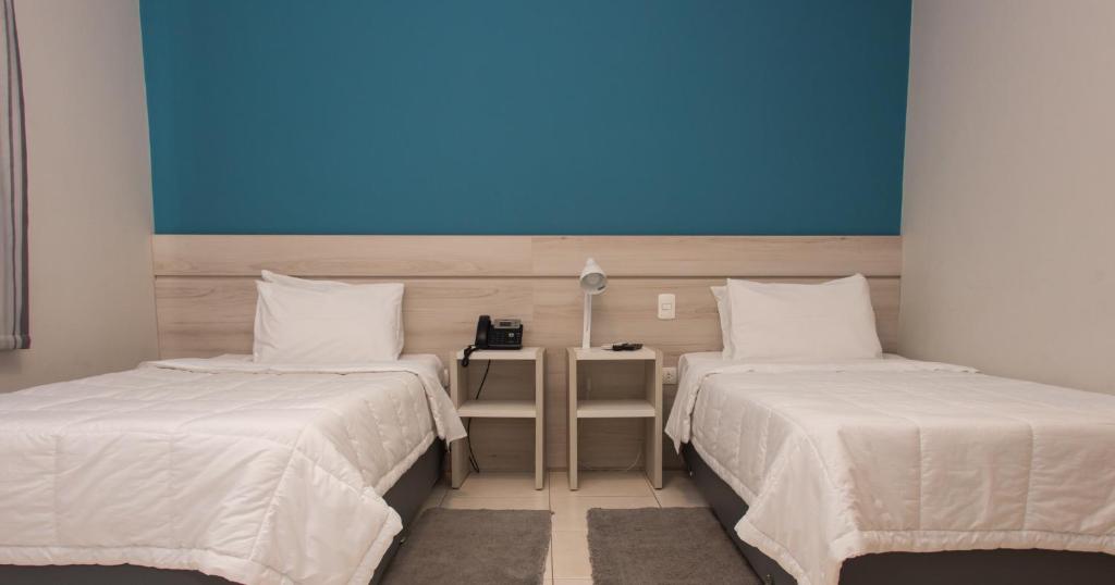 Postel nebo postele na pokoji v ubytování Nova Hotel