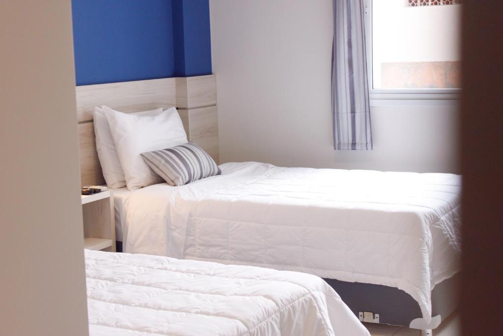 Postel nebo postele na pokoji v ubytování Nova Hotel