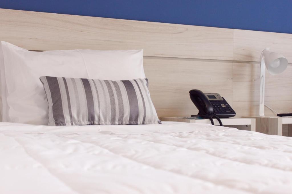 Postel nebo postele na pokoji v ubytování Nova Hotel