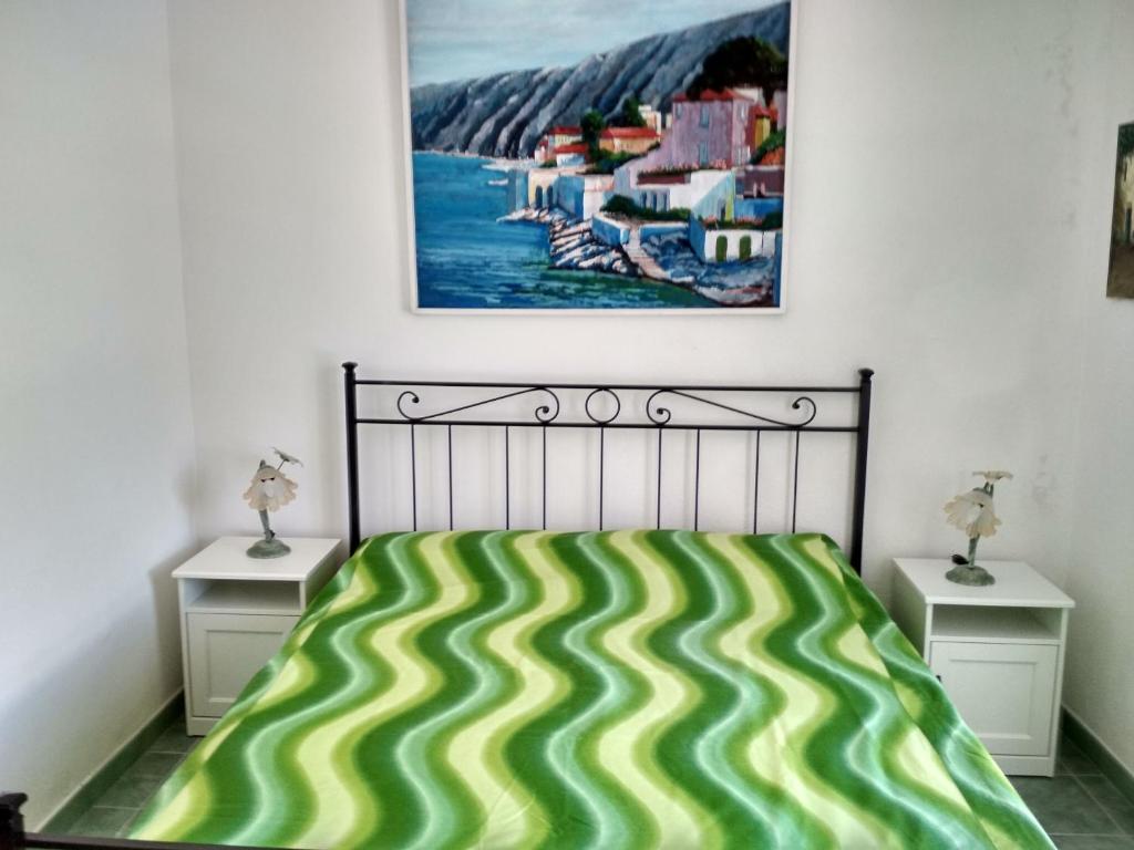 a bedroom with a bed and two night stands at La casa Verde in Ischia